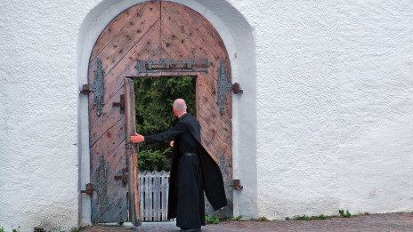 Duhovnik pred vrati samostana (photo: Pixabay)
