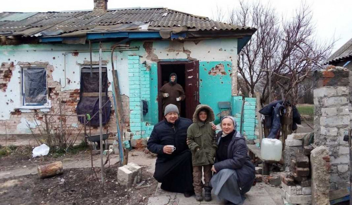 Prebivalci Černihivske regije pred porušeno hišo, ob njih predstavniki Karitas (foto: Karitas Spes)